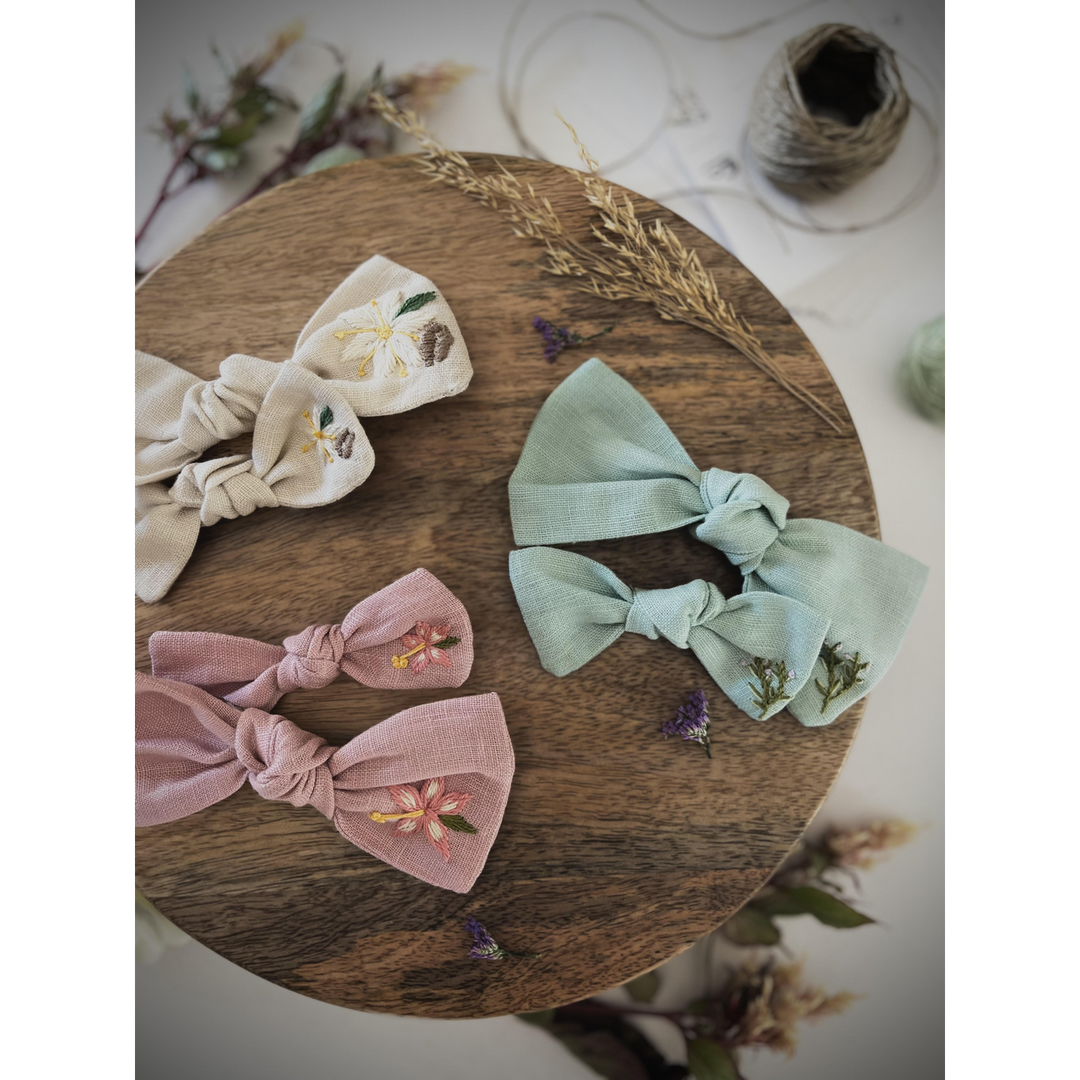 Embroidered linen bow with alligator clip attachment