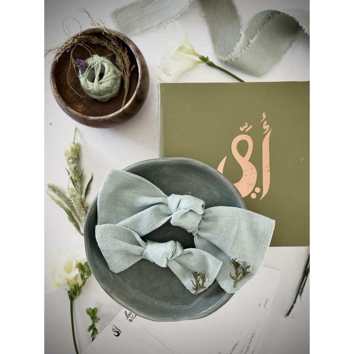 Embroidered linen bow with alligator clip attachment