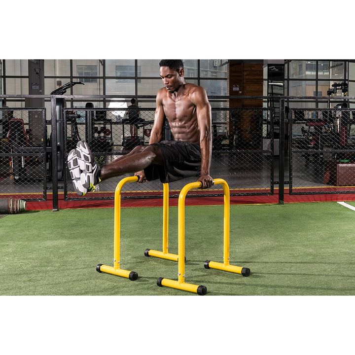 Parallel bars with black and yellow grips for strength training