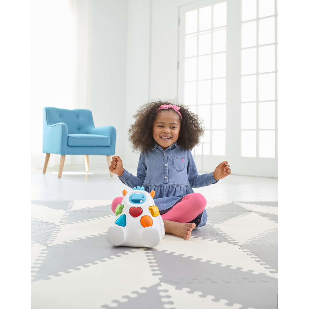 Skip Hop Playspot Geo foam floor tiles in a triangle pattern.