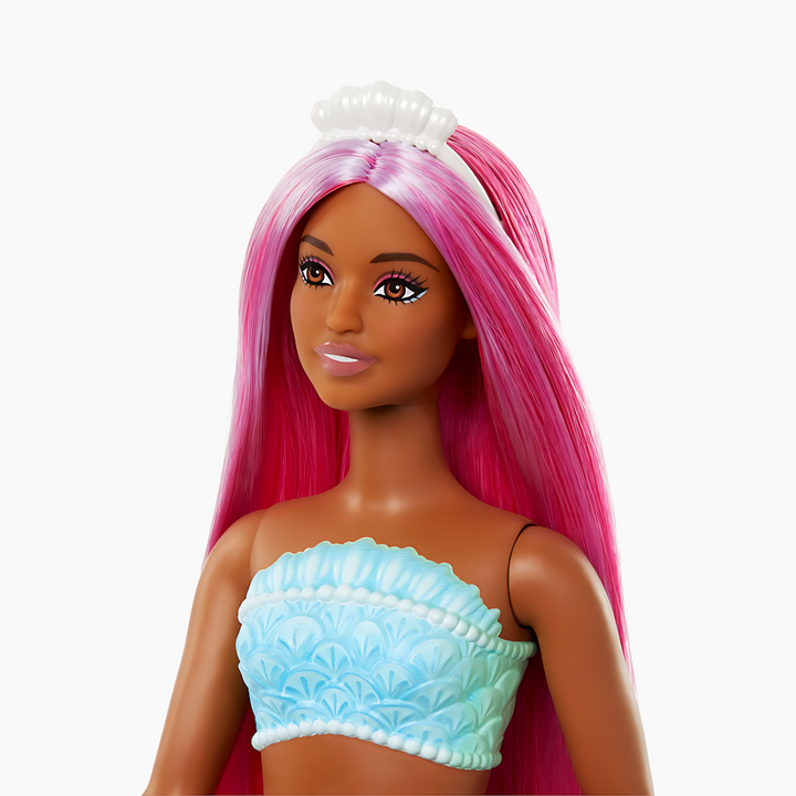 Barbie mermaid doll with magenta hair, curvy body, shell bodice, and tropical red tail
