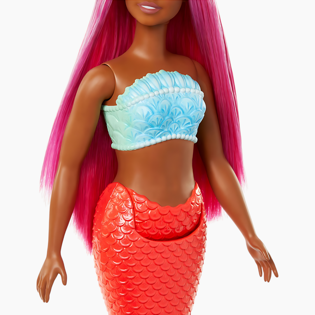 Barbie mermaid doll with magenta hair, curvy body, shell bodice, and tropical red tail